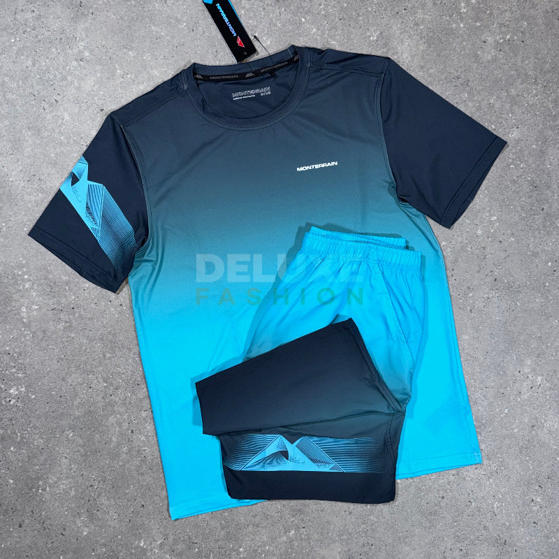 A two-piece athletic set laid flat on a gray concrete surface, featuring a short-sleeve gradient shirt and matching shorts. The shirt has a dark navy-to-turquoise gradient with a geometric pattern on the sleeve, and the shorts are dark navy with a matching geometric pattern.